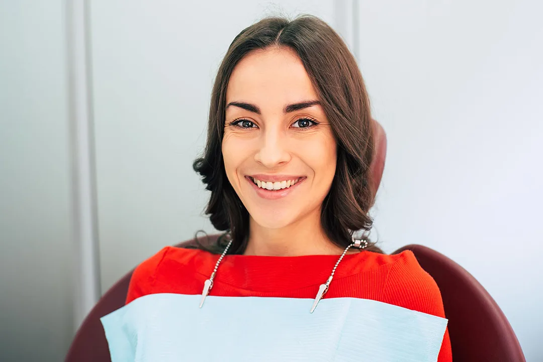 A dental hygienist performing a professional teeth cleaning on a patient